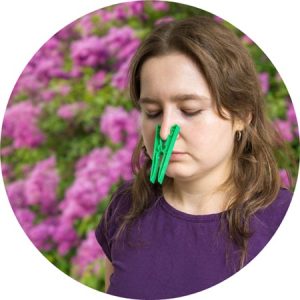 Lady pinning her nose closed to avoid allergies in Austin, Texas