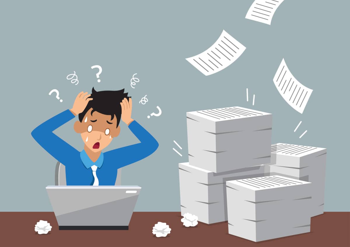 business owner in front of a laptop overwhelmed by the amount of blogging they think they need to do